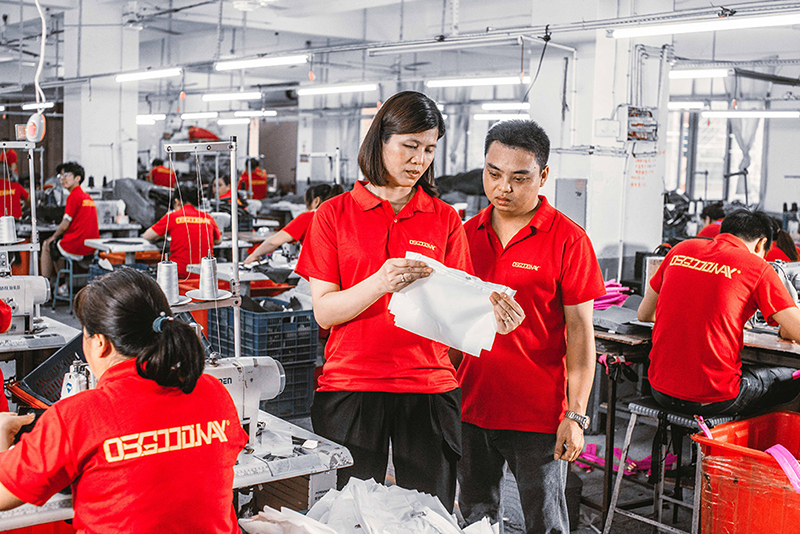 The R&D team reviewing a paper tech pack against a finished golden sample